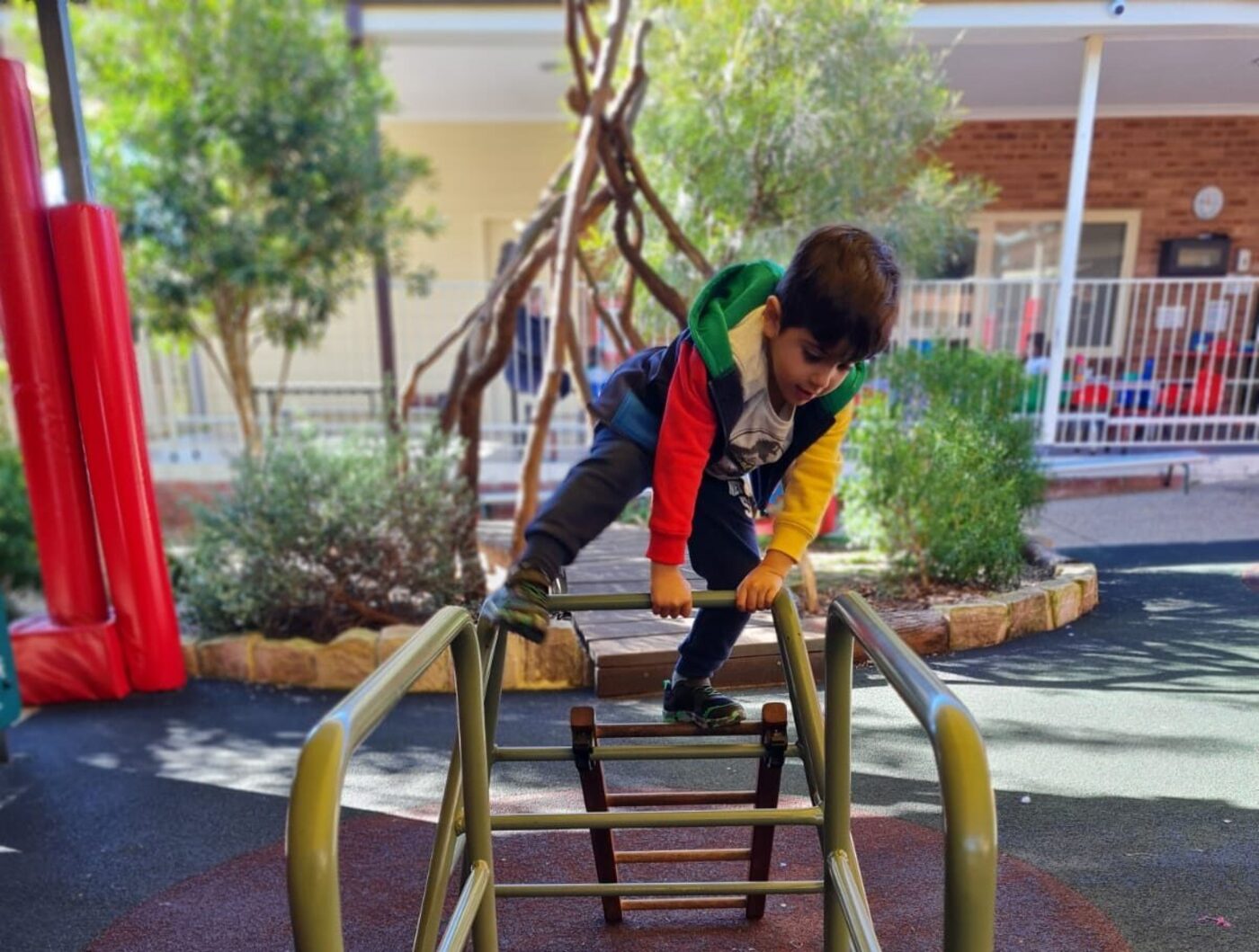 A child climbing timber play equipment in the centre playground